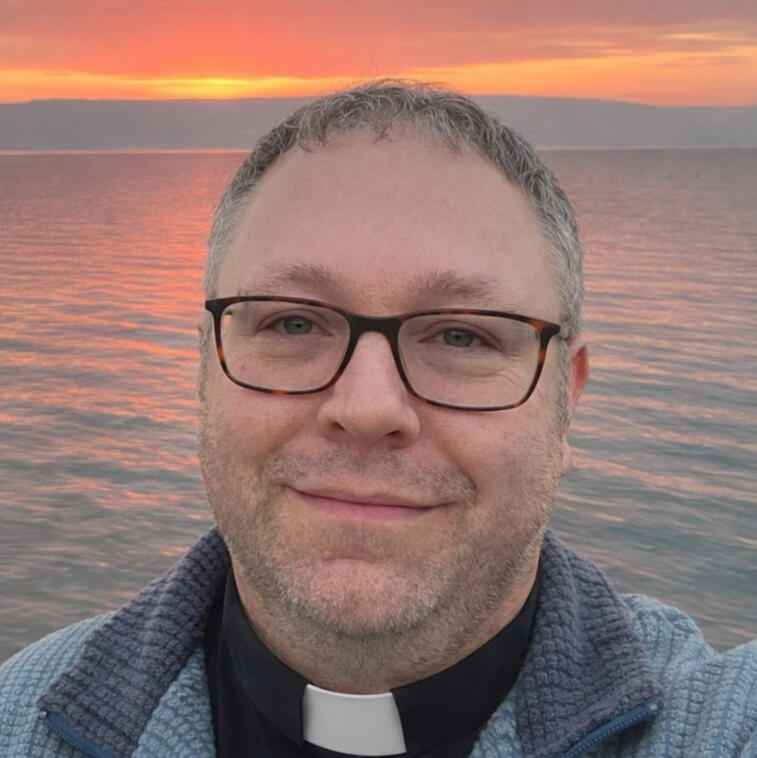 Image of Rev'd Mike Green in front of the Sea of Galilee at Sunrise